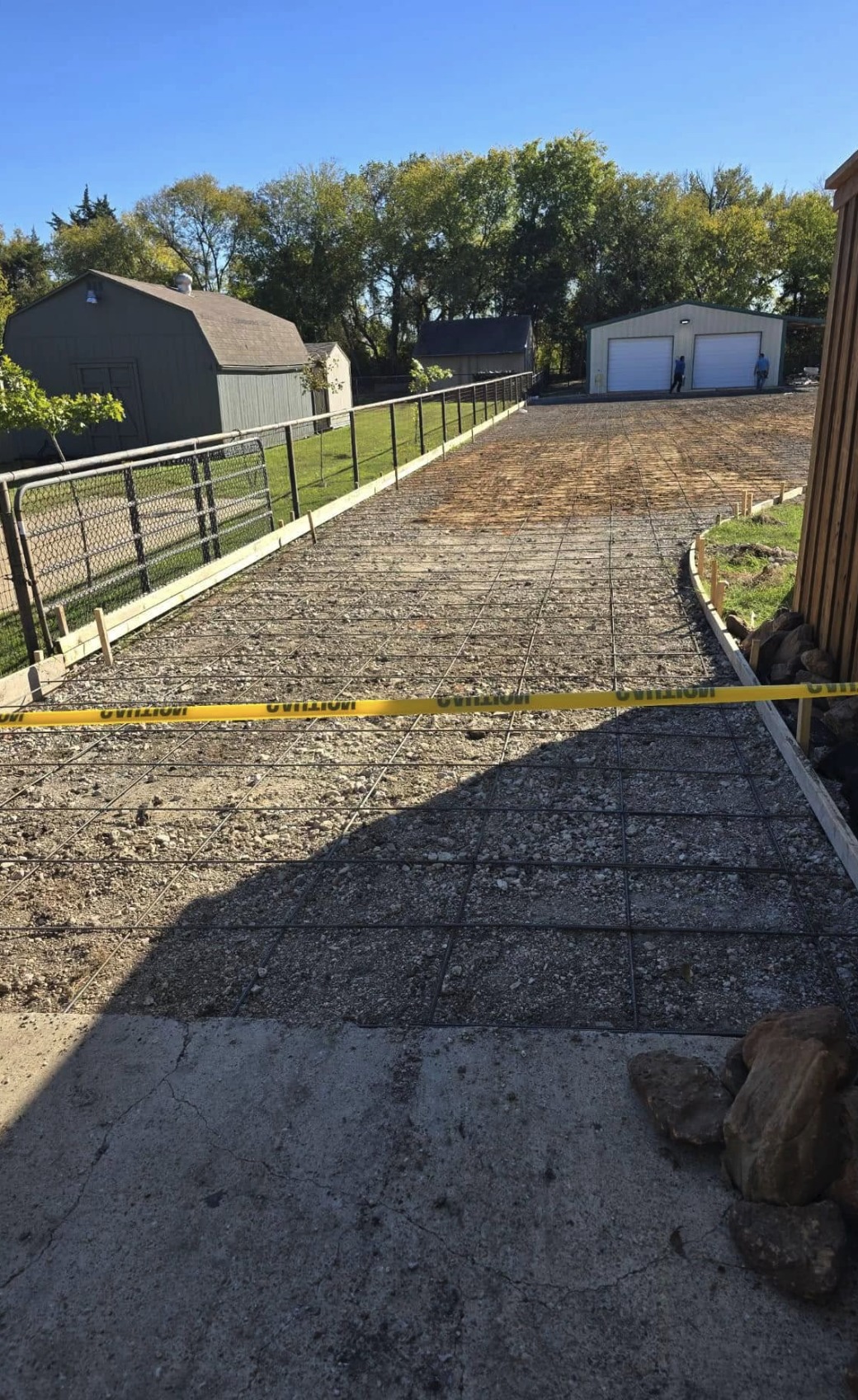 Driveway forms and steel laid out before a concrete pour