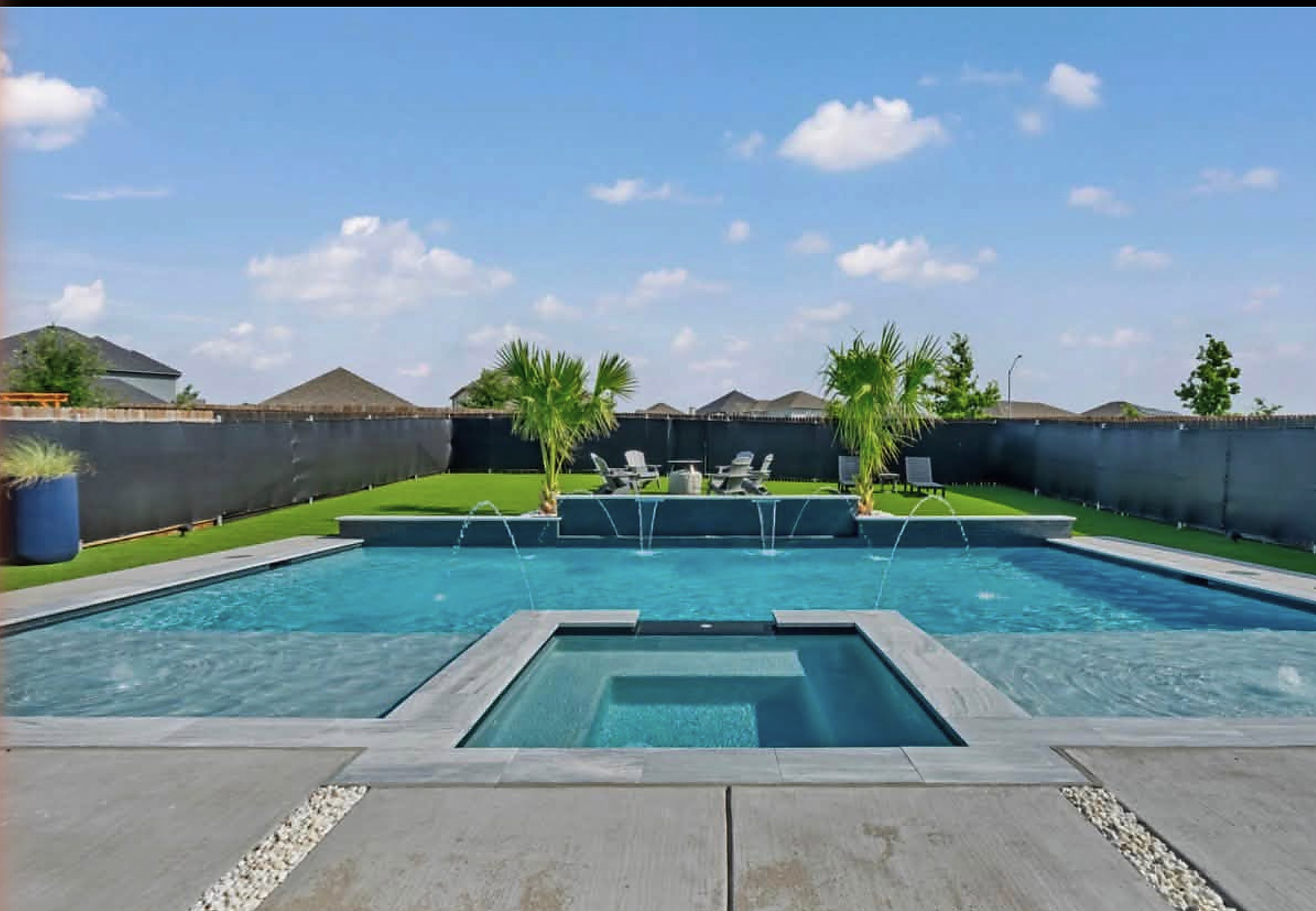 Rectangular pool with a flush spa and bubblers